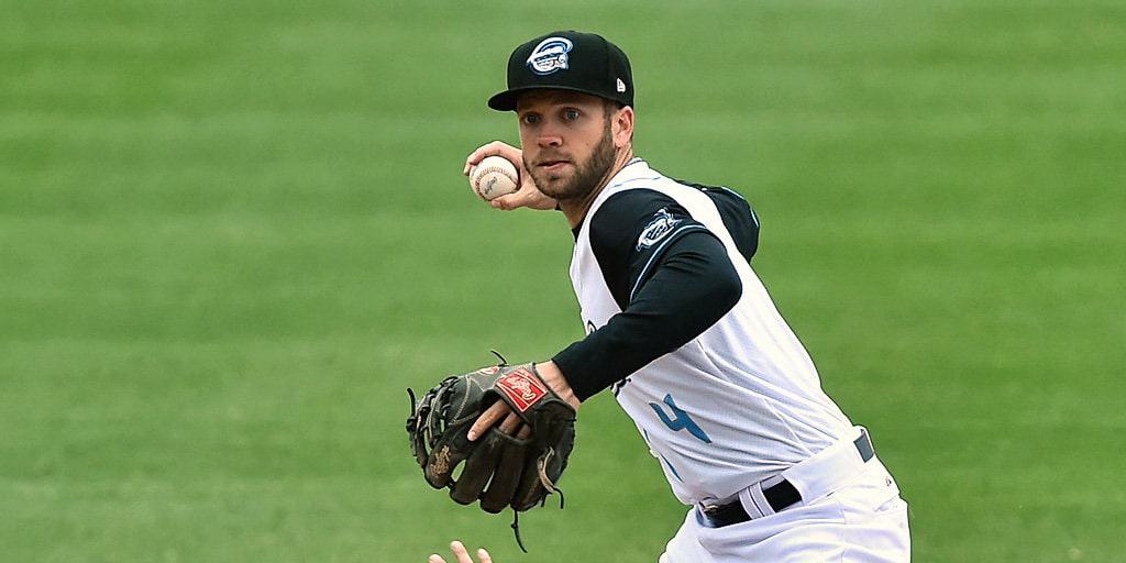 Cutter Dykstra in a black and white baseball jersey ready to bowl in baseball diamond.